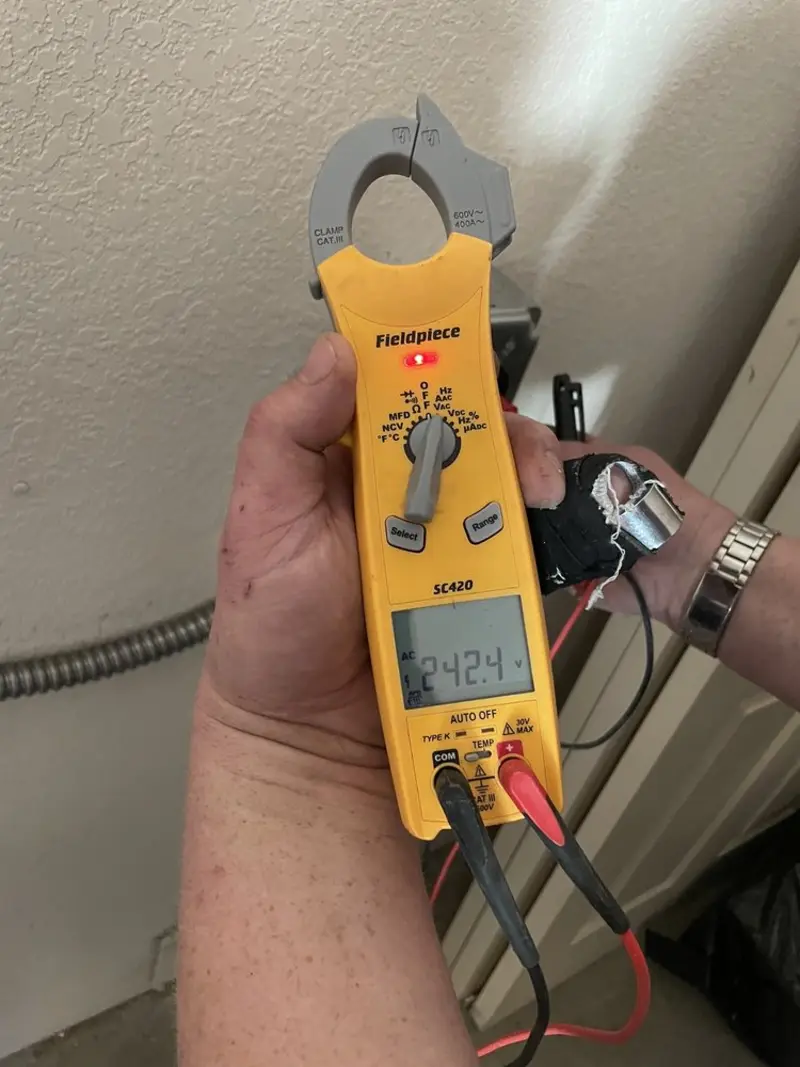 Voltage testing with clamp meter during Whole House Surge Protector in Des Peres
